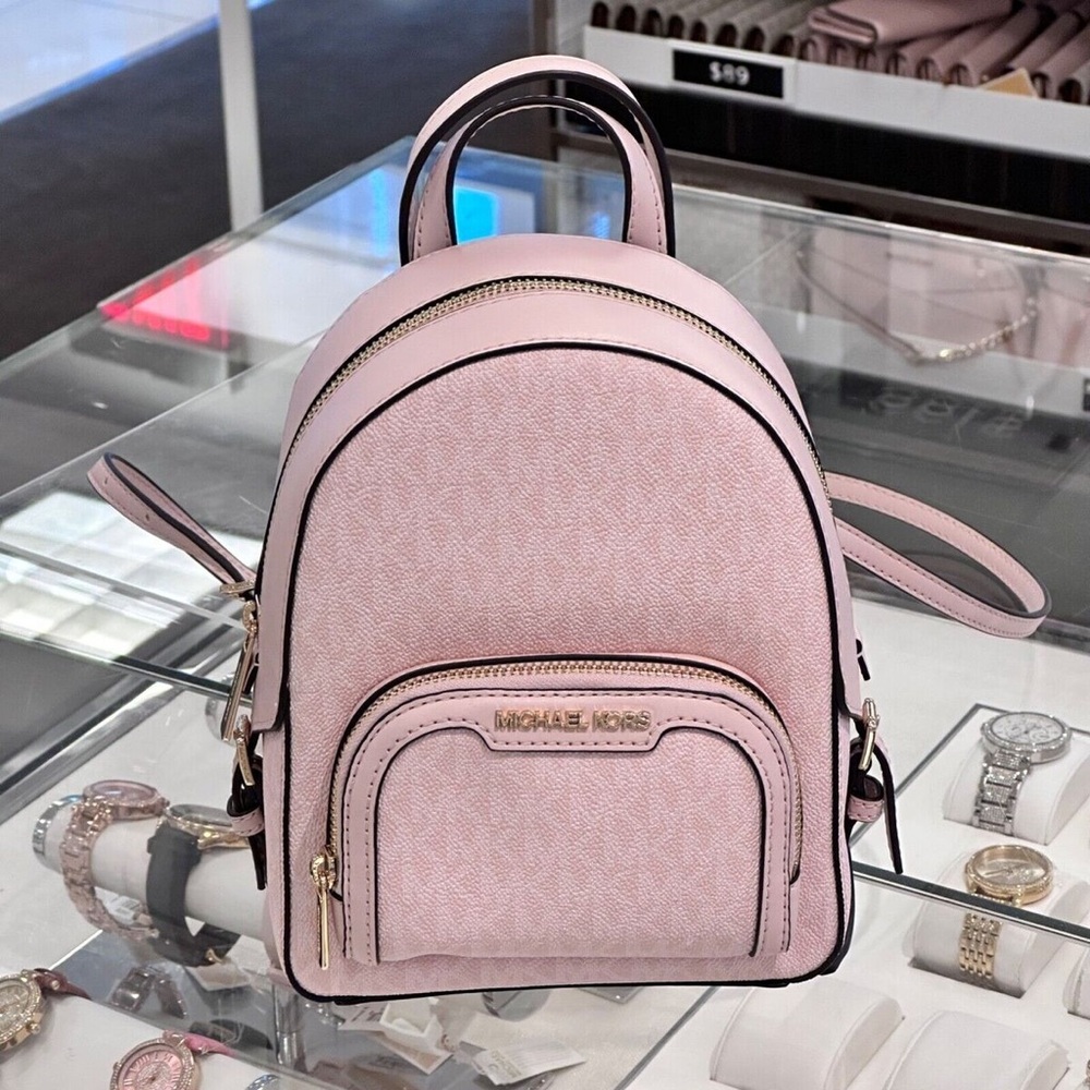 Michael Kors Pink Backpack with Gold Accents and Monogram Design
